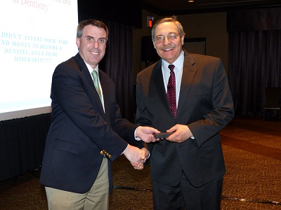 Dr. Matthew Zizmor receiving a lifetime achievement award pin from the American Dental Association, and the Massachusetts Dental Society